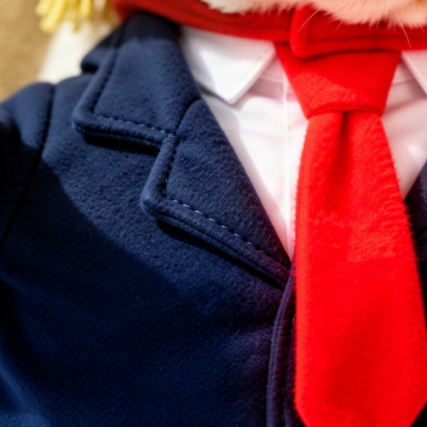 Macro close-up of the fleece-like jacket fabric and the red plush tie