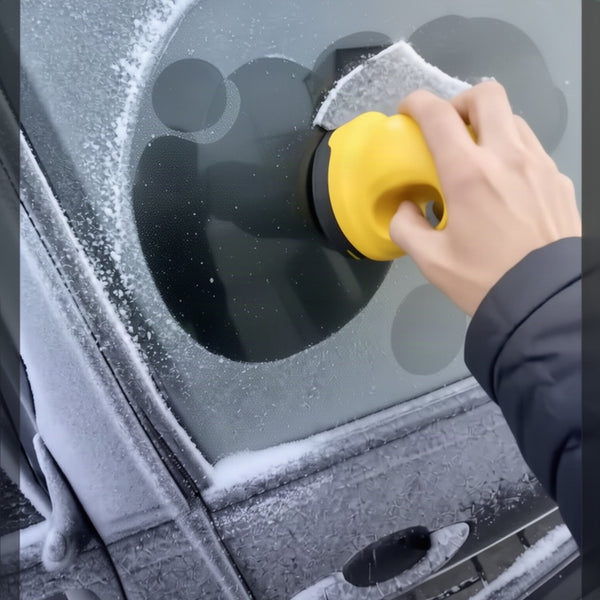 Round patches of frost cleared from a side window