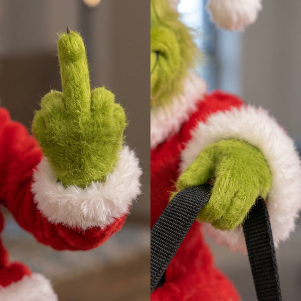 Close-up of one raised green hand and the other hand holding the black rein strap