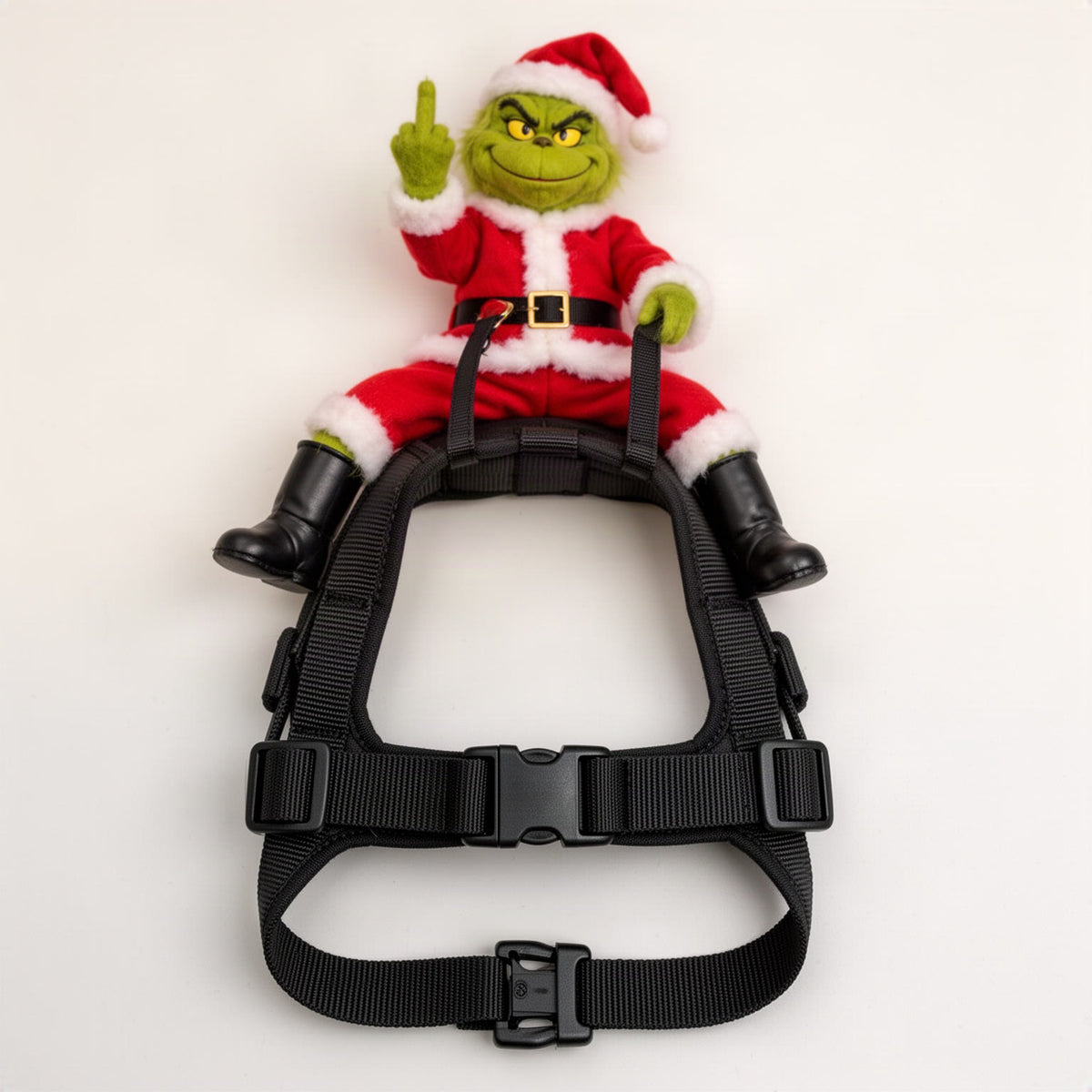Product-only shot of the black harness laid open, showing the wide buckle strap and the small clip at the bottom edge
