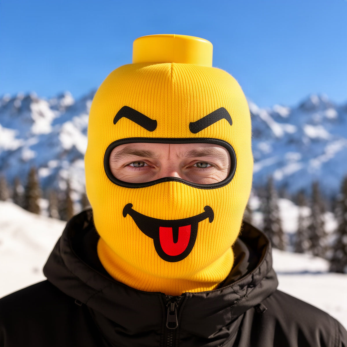 Close-up of the yellow smiley mask on a person, showing the raised cylinder on top, the angry eyebrows, the black-outlin